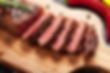 Sliced steak on cutting board